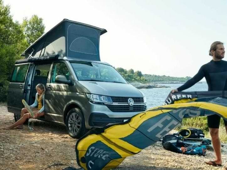 A couple with a VW Camper California